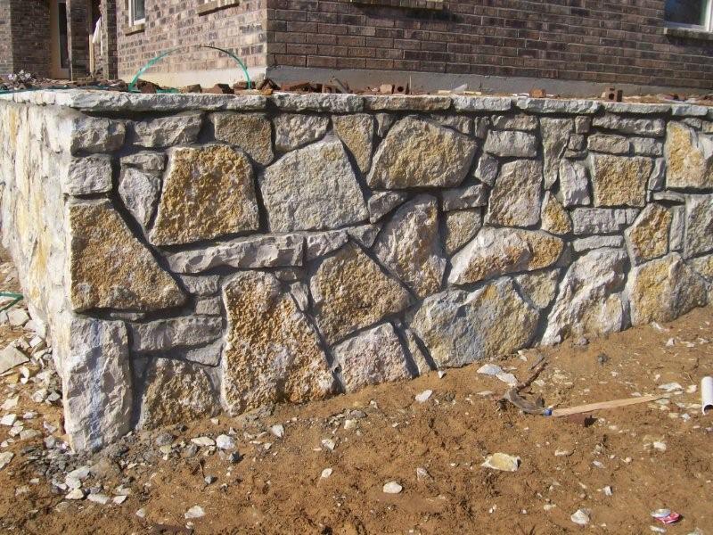 A houses Retaining wall built out of Multi-Color Retaining Wall